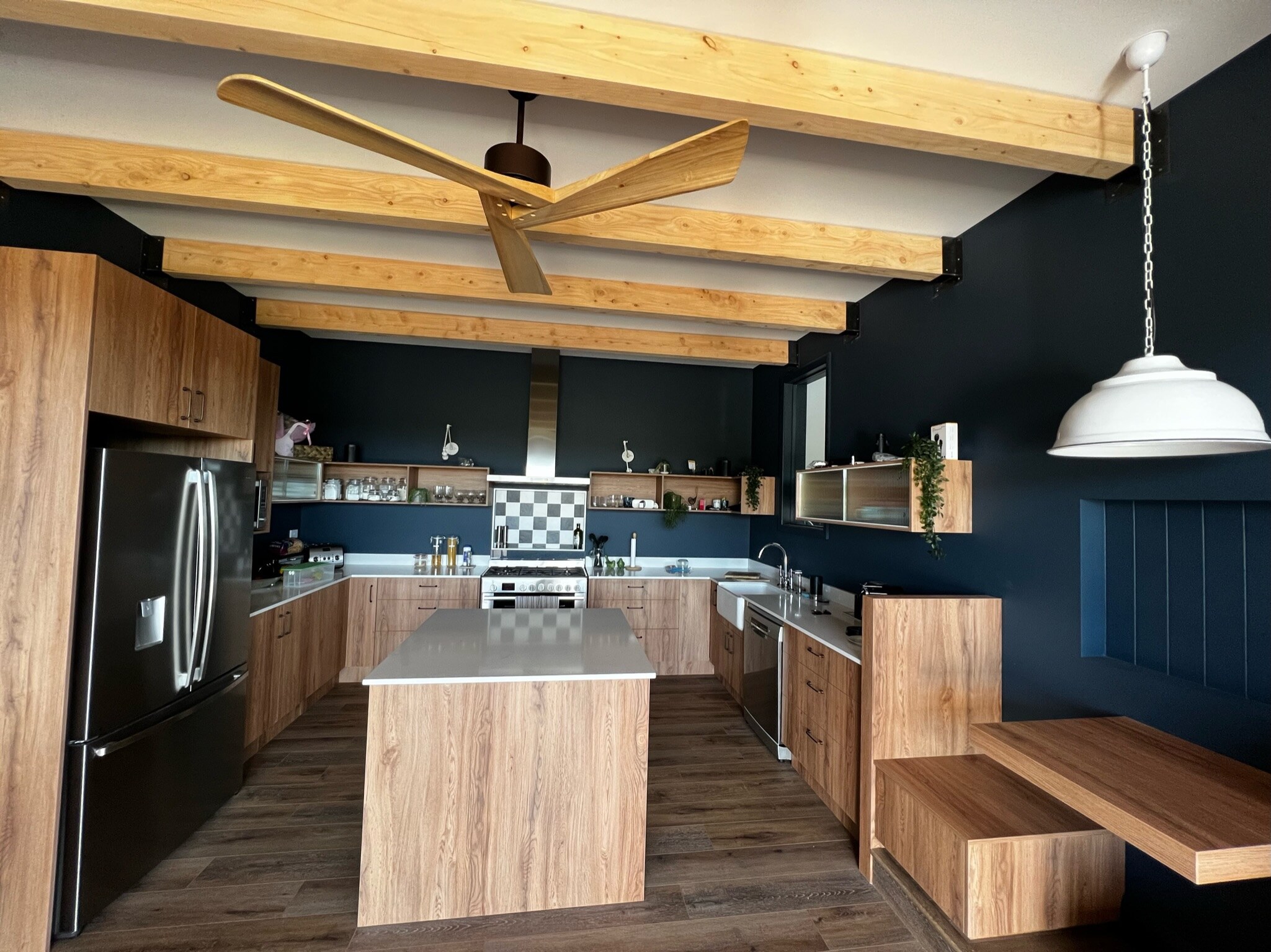 Kitchen and dining with large island and booth seating