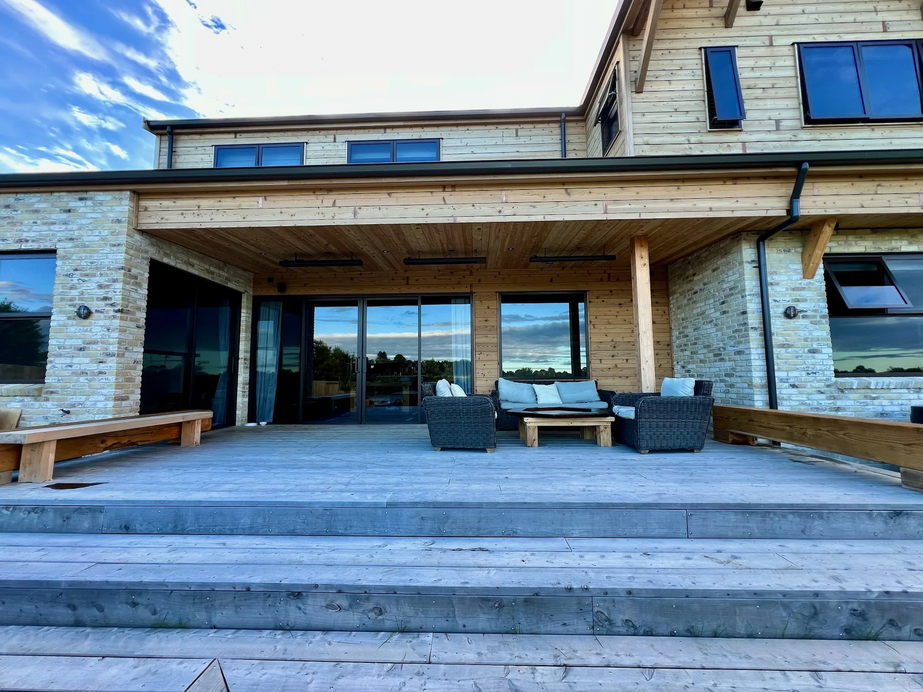 Covered rear alfresco living with macrocarpa deck